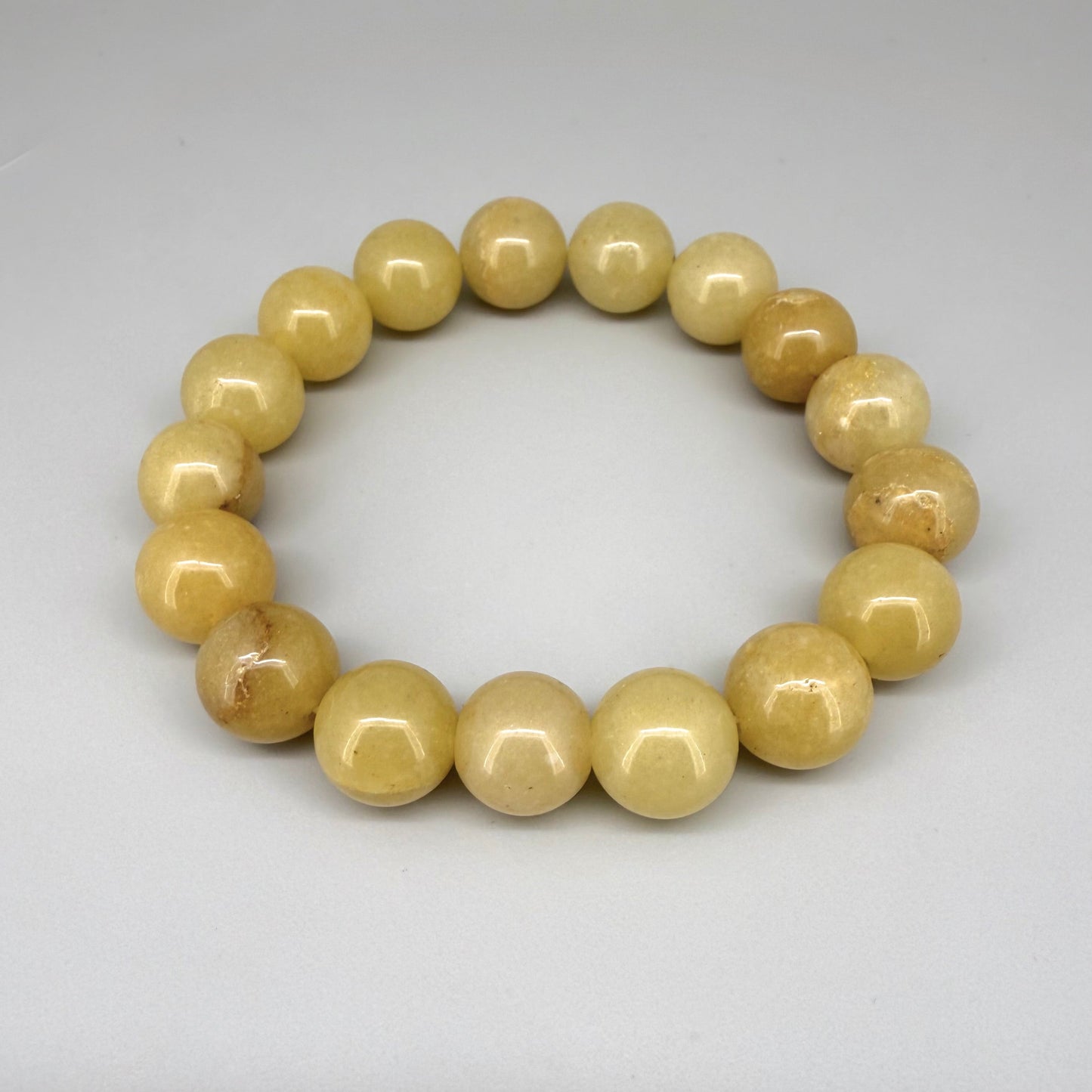 Jade beaded bracelet, 19cm, natural yellow-cream gemstone beads on elastic stretch band.