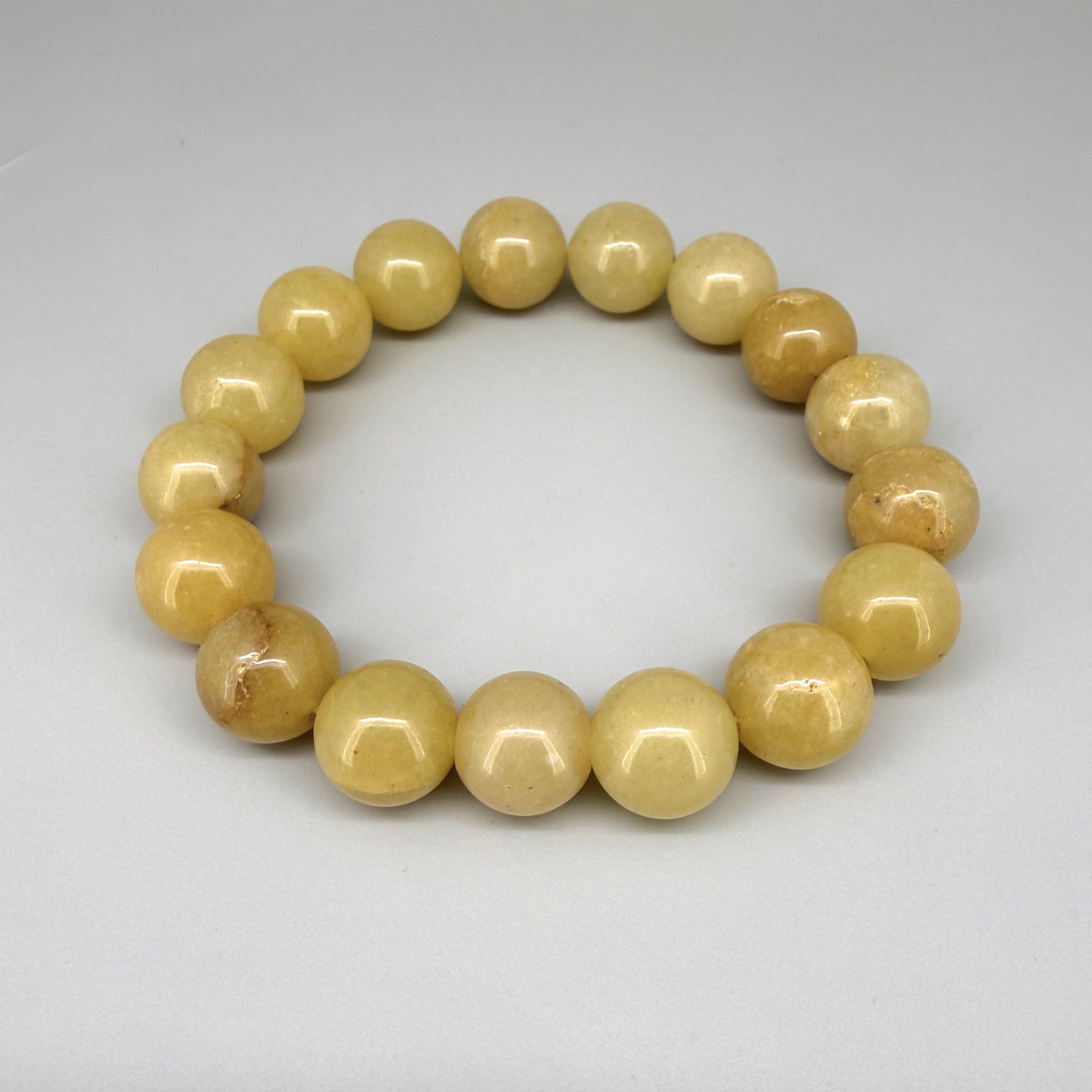 Jade beaded bracelet, 19cm, natural yellow-cream gemstone beads on elastic stretch band.