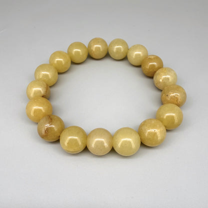 Jade beaded bracelet, 19cm, natural yellow-cream gemstone beads on elastic stretch band.