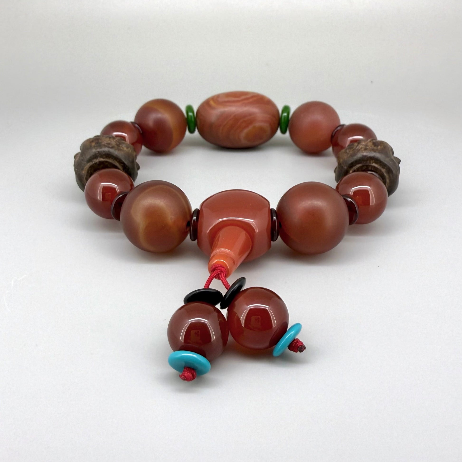 Agate and carnelian beaded bracelet, 20cm, with fiery red, orange, and colorful accent beads on elastic stretch band.