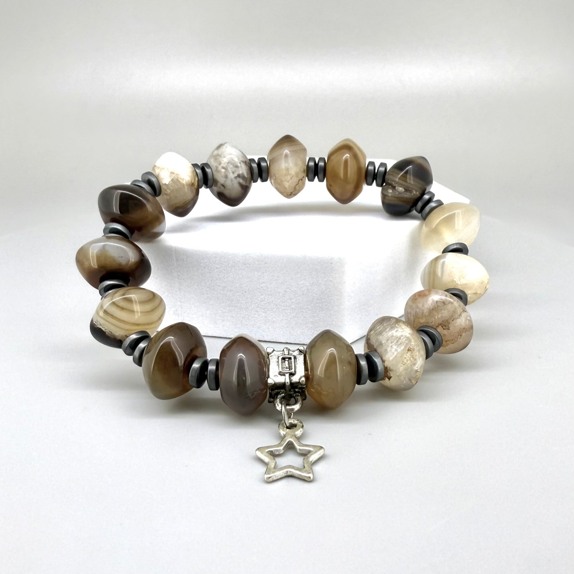 Agate and hematite beaded bracelet, 19cm, beige-brown gemstone beads with metallic hematite accents and silver star charm on elastic stretch band.