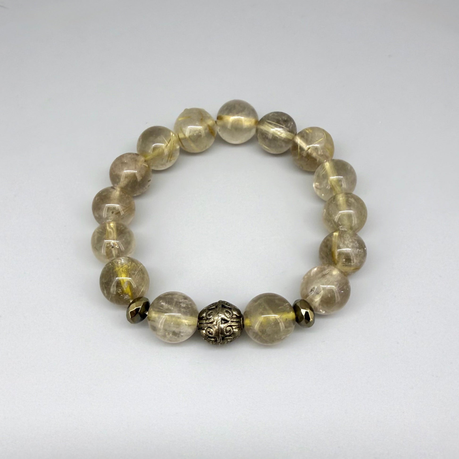 Rutilated quartz beaded bracelet, natural golden rutile gemstone beads with one carved metal accent bead on elastic stretch band.