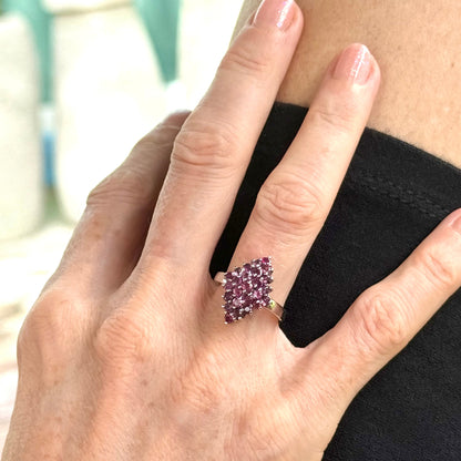 Ruby cluster ring in white gold plated sterling silver, featuring multiple faceted natural rubies in geometric design, elegant and radiant look.