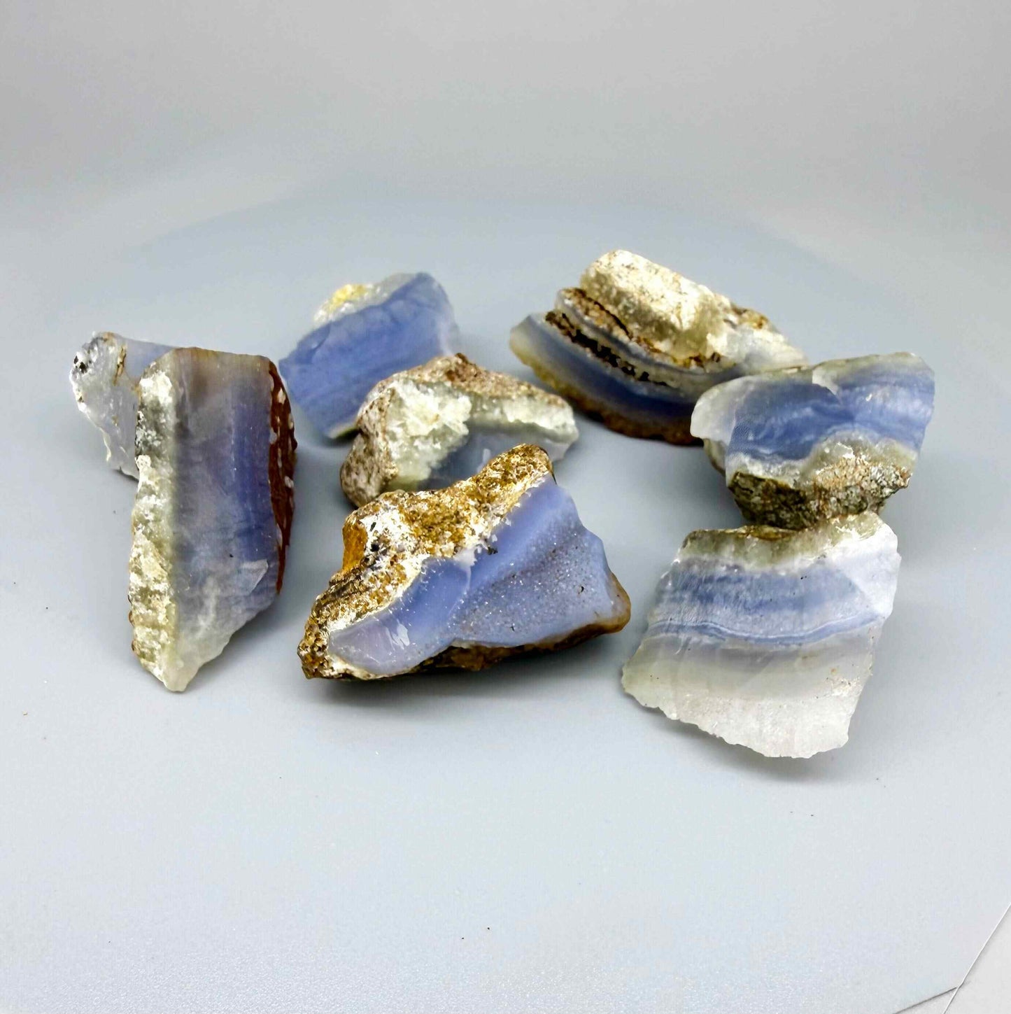 Untreated blue chalcedony rough lot with milky appearance and natural banding