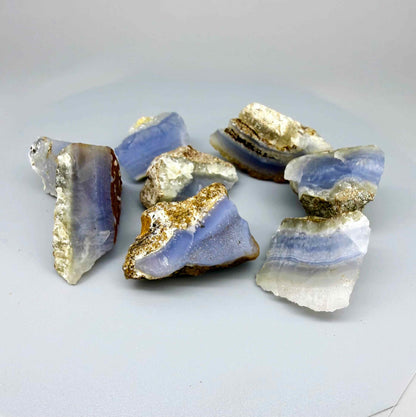 Untreated blue chalcedony rough lot with milky appearance and natural banding