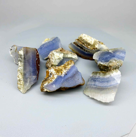 Untreated blue chalcedony rough lot with milky appearance and natural banding