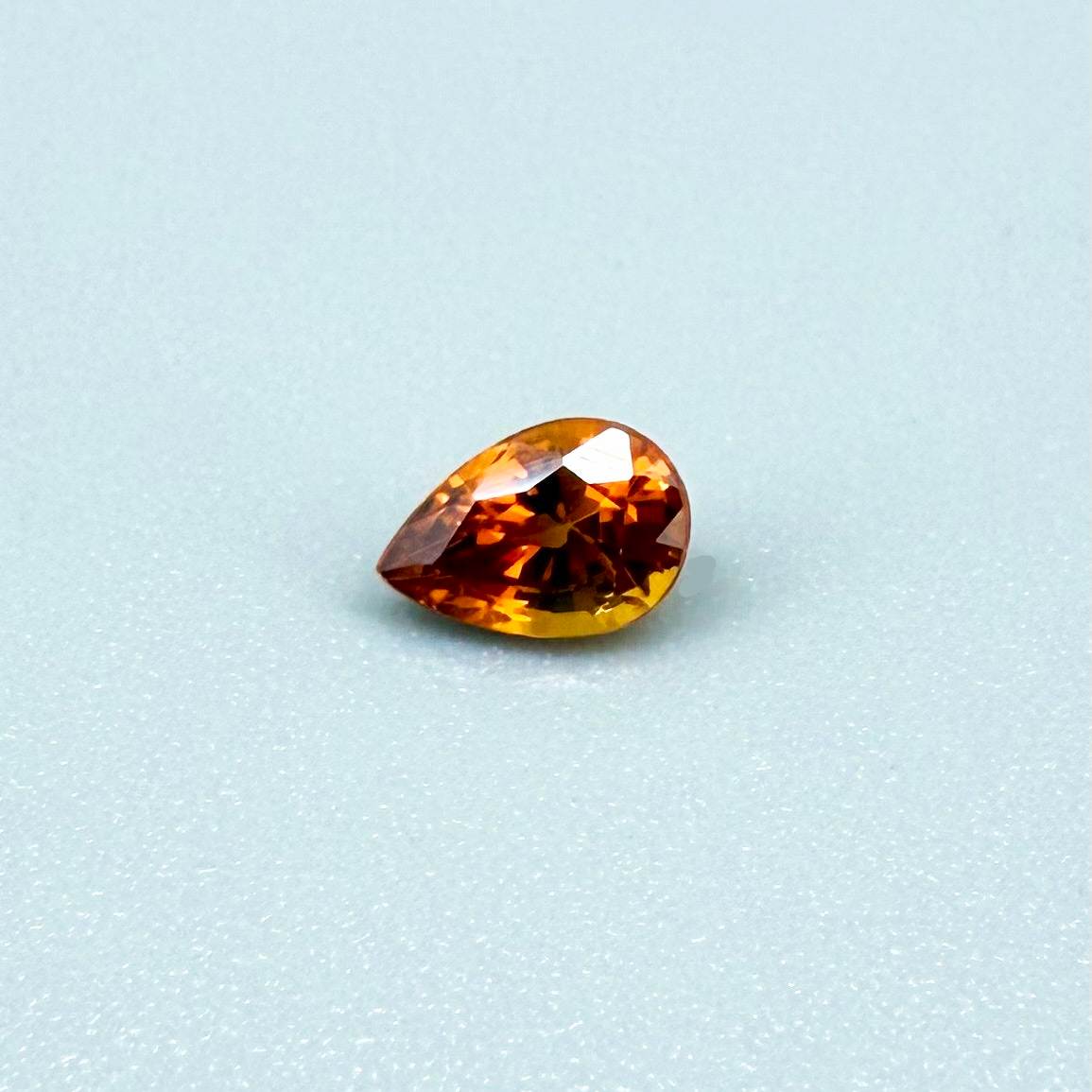 0.5 ct natural fiery-orange spessartine garnet from Namibia, pear cut.