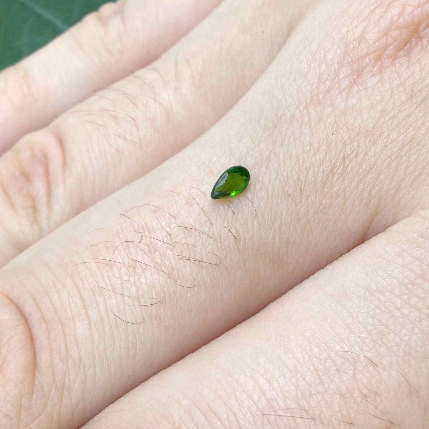0.14 ct natural green diopside, pear cut.