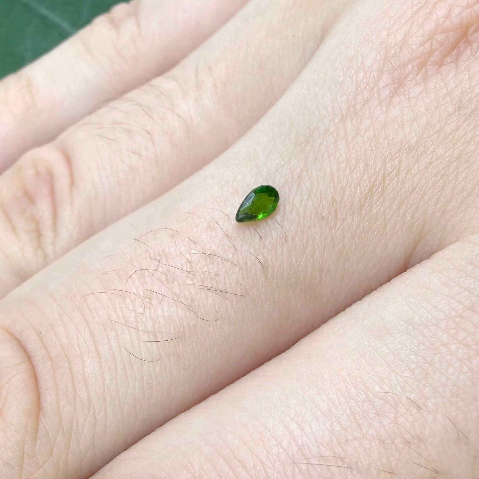 0.14 ct natural green diopside, pear cut.