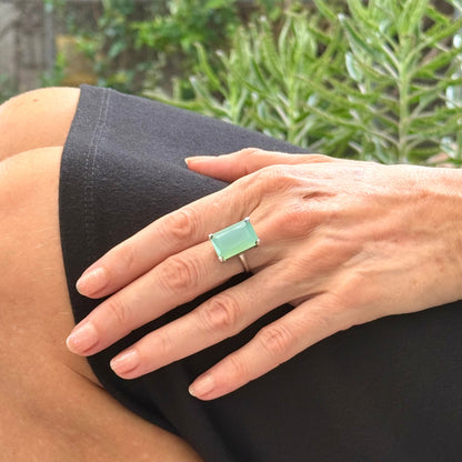 Green chalcedony ring in white gold plated sterling silver, featuring a rectangular-cut soft mint green gemstone with gentle translucence, elegant design.