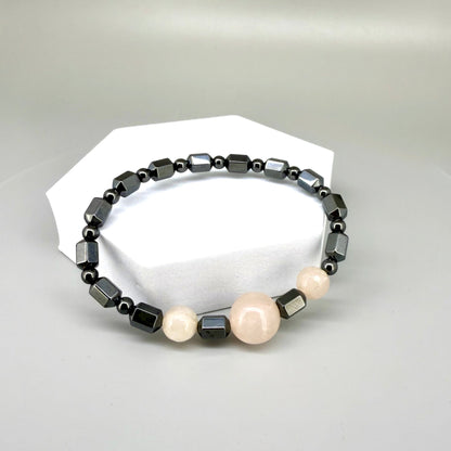 Hematite and rose quartz beaded bracelet, 18cm, geometric metallic grey beads with three pink rose quartz accents on elastic stretch band.