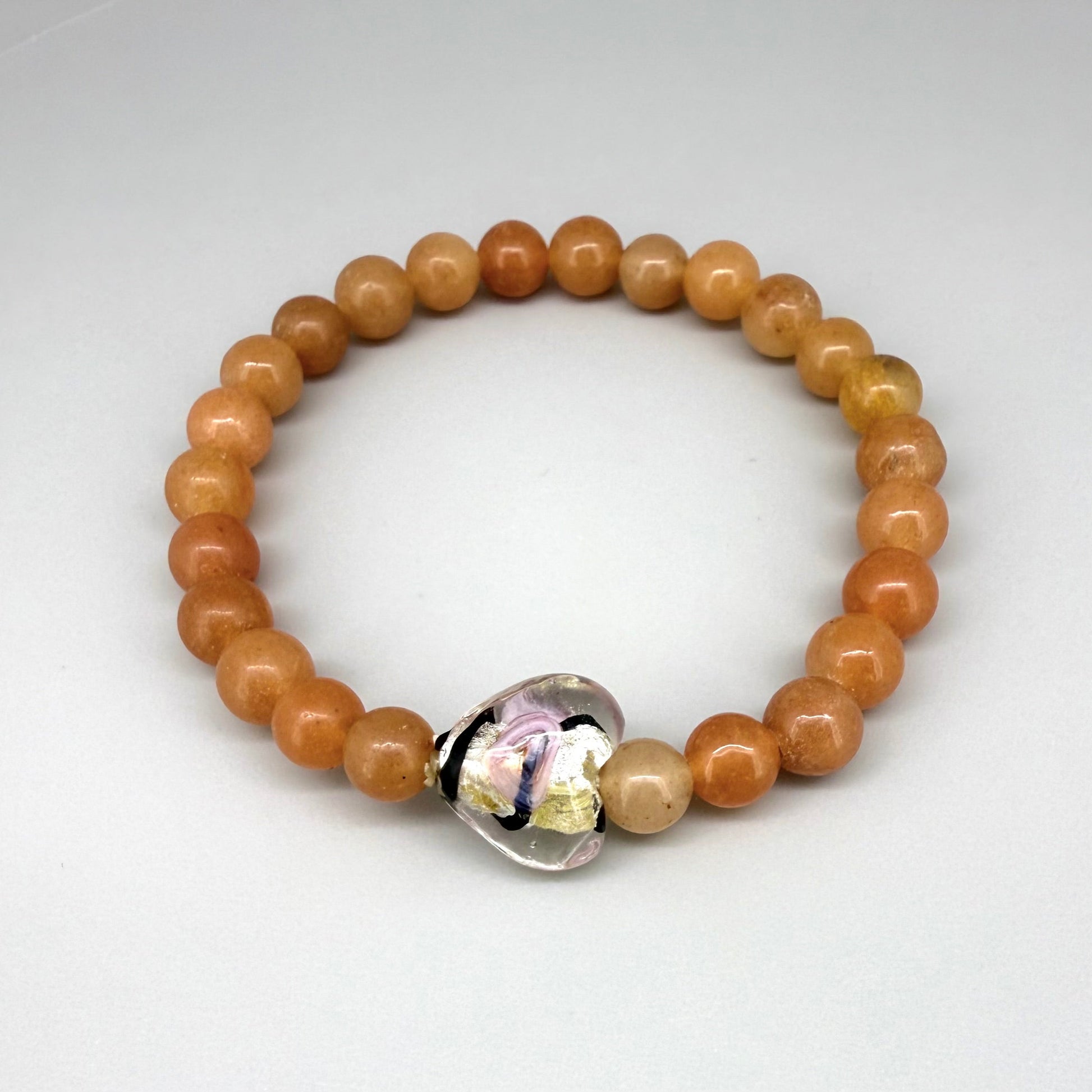 Agate beaded bracelet, 16cm, orange gemstone beads with glass heart focal bead on elastic stretch band.