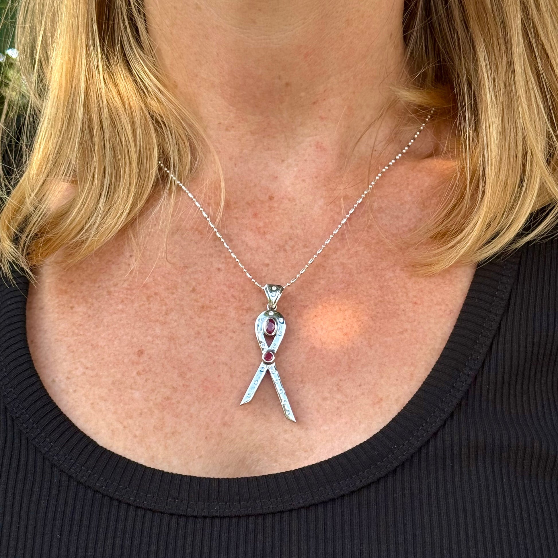 Modern handcrafted pendant in white-gold-plated silver with two natural rubies (1.73 ct total) and cubic zirconia accents