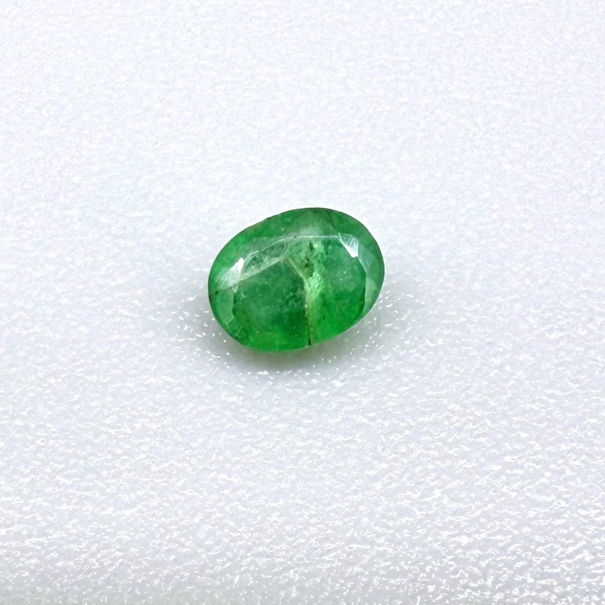 0.18 ct natural untreated Zambian emerald, oval faceted with bright bluish-green color.
