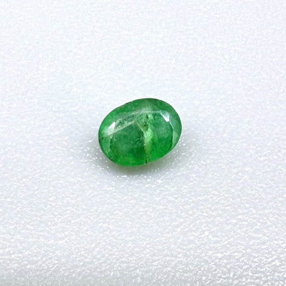 0.18 ct natural untreated Zambian emerald, oval faceted with bright bluish-green color.