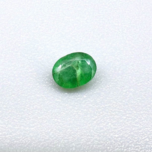 0.18 ct natural untreated Zambian emerald, oval faceted with bright bluish-green color.