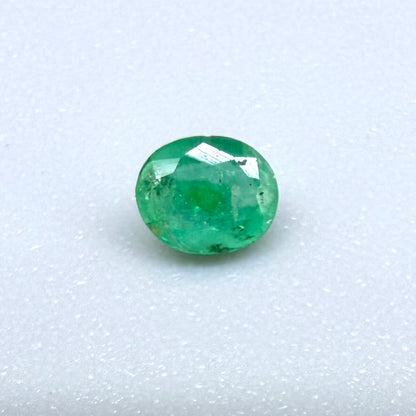 0.2 ct natural untreated Zambian emerald, oval faceted with bright bluish-green color.