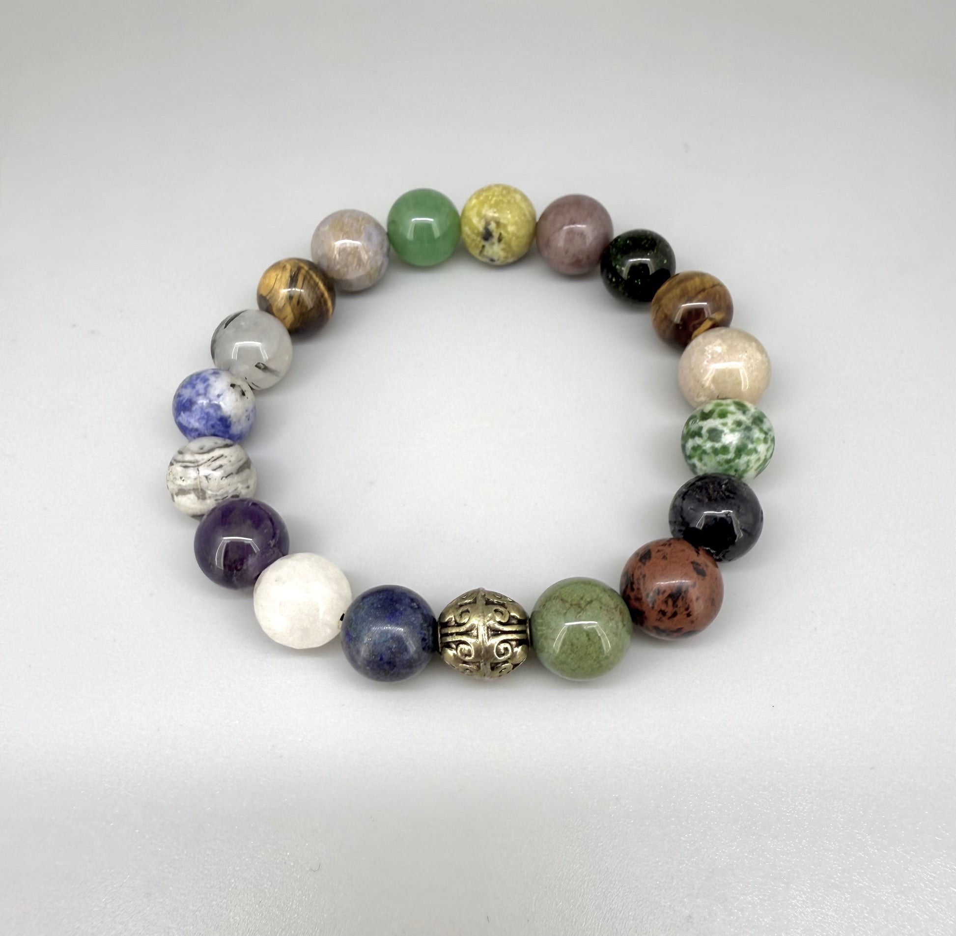 Multi-gemstone beaded bracelet, 18cm, with lapis lazuli, quartz, moonstone, amethyst, jasper, green fluorite, and rutilated quartz beads on elastic stretch band.