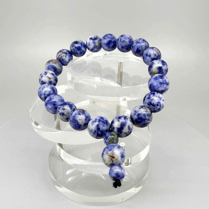 Blue Jasper mala bracelet with marbled blue and white natural gemstone beads and decorative charm detail.