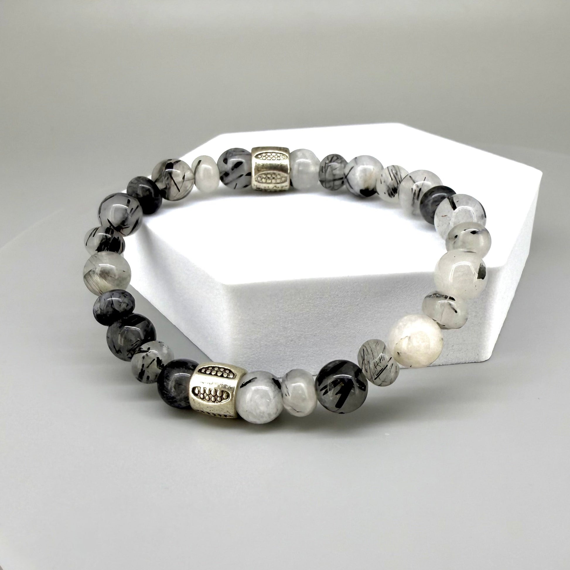 Rutilated quartz beaded bracelet, 18cm, black-white-grey gemstone beads with two decorated metal spacers on elastic band.