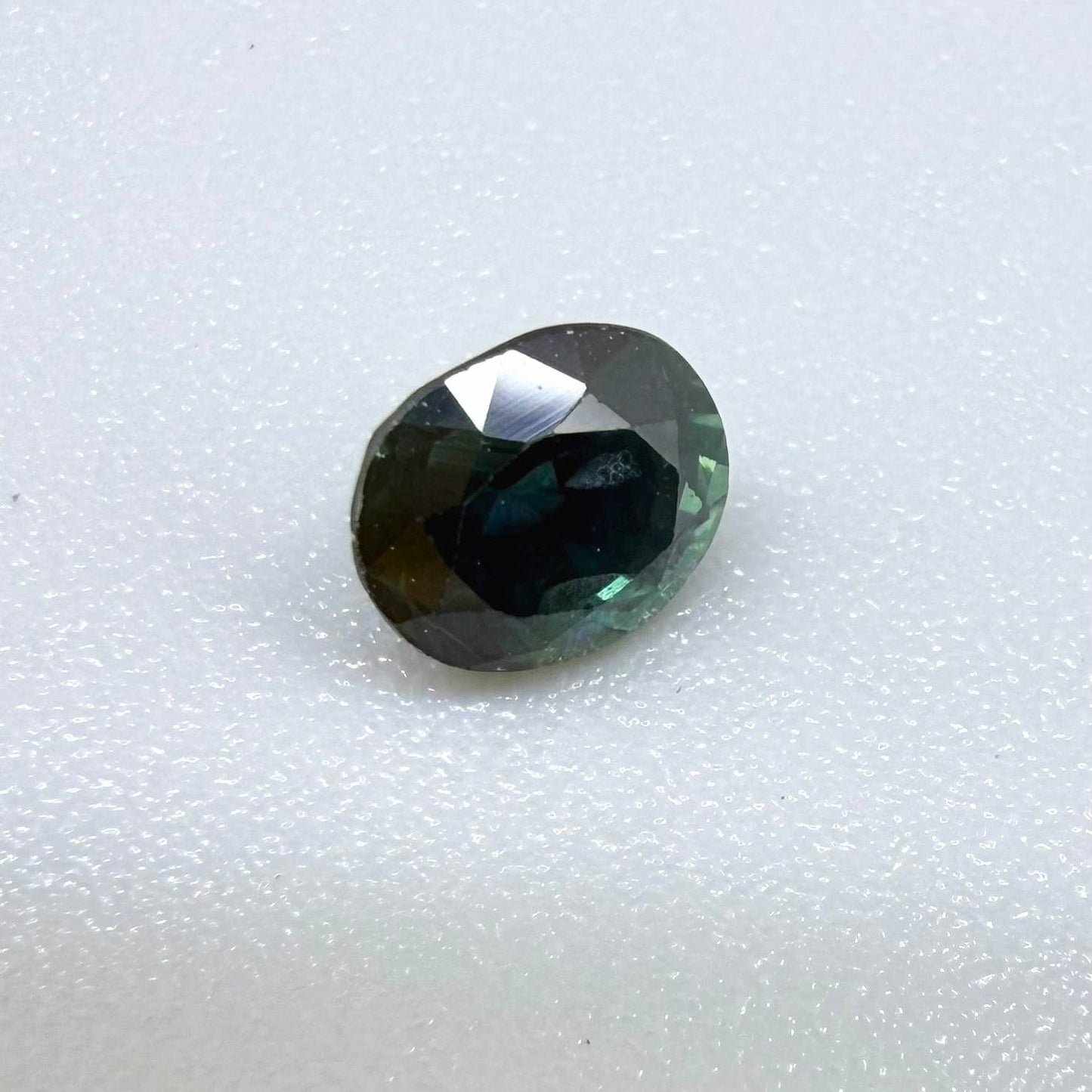 0.67 ct natural blue-green sapphire from Bangkaja, faceted cut.