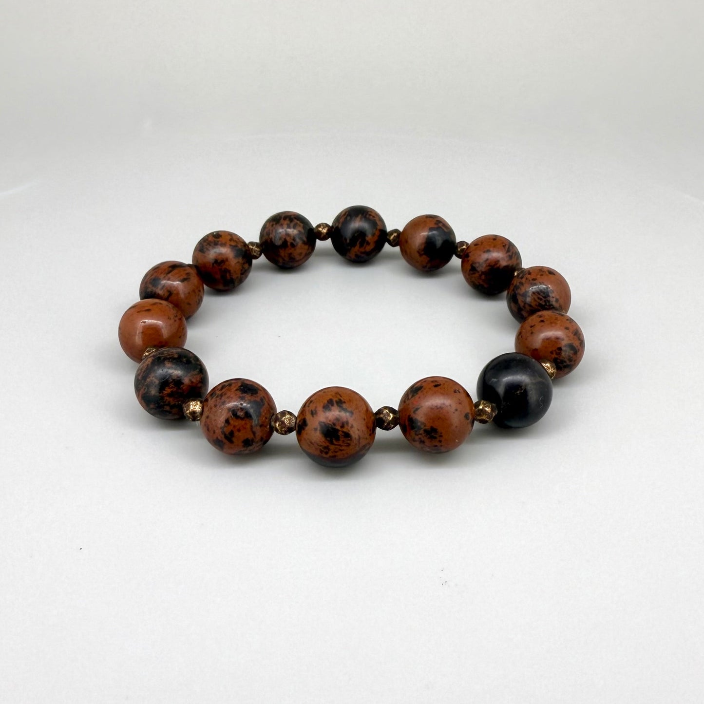Mahogany obsidian beaded bracelet, 17cm, natural brown and black gemstone beads with small copper accents on elastic stretch band.