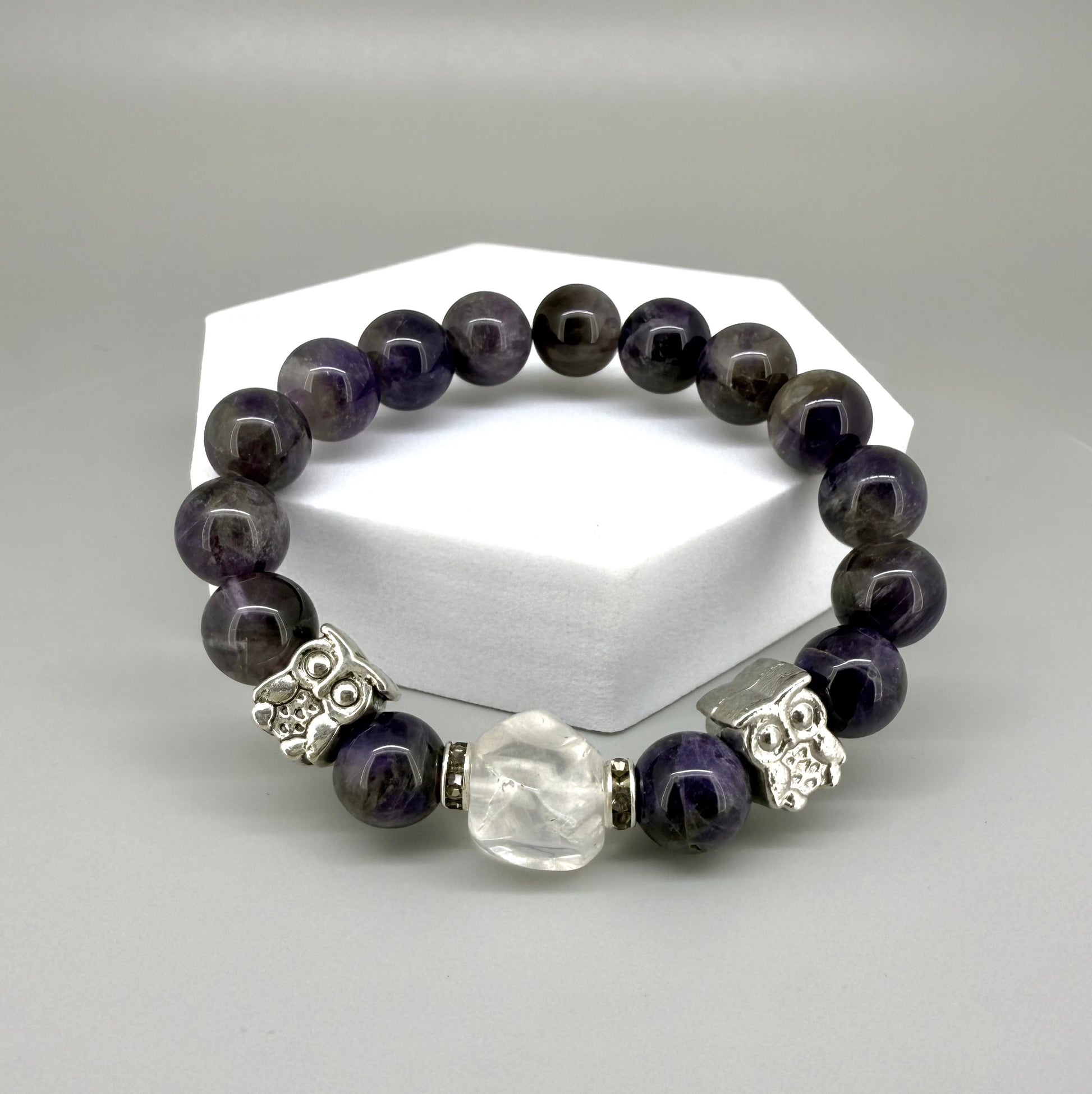 Amethyst beaded bracelet, 18cm, violet gemstone beads with large clear white focal stone and two owl accents on elastic stretch band.