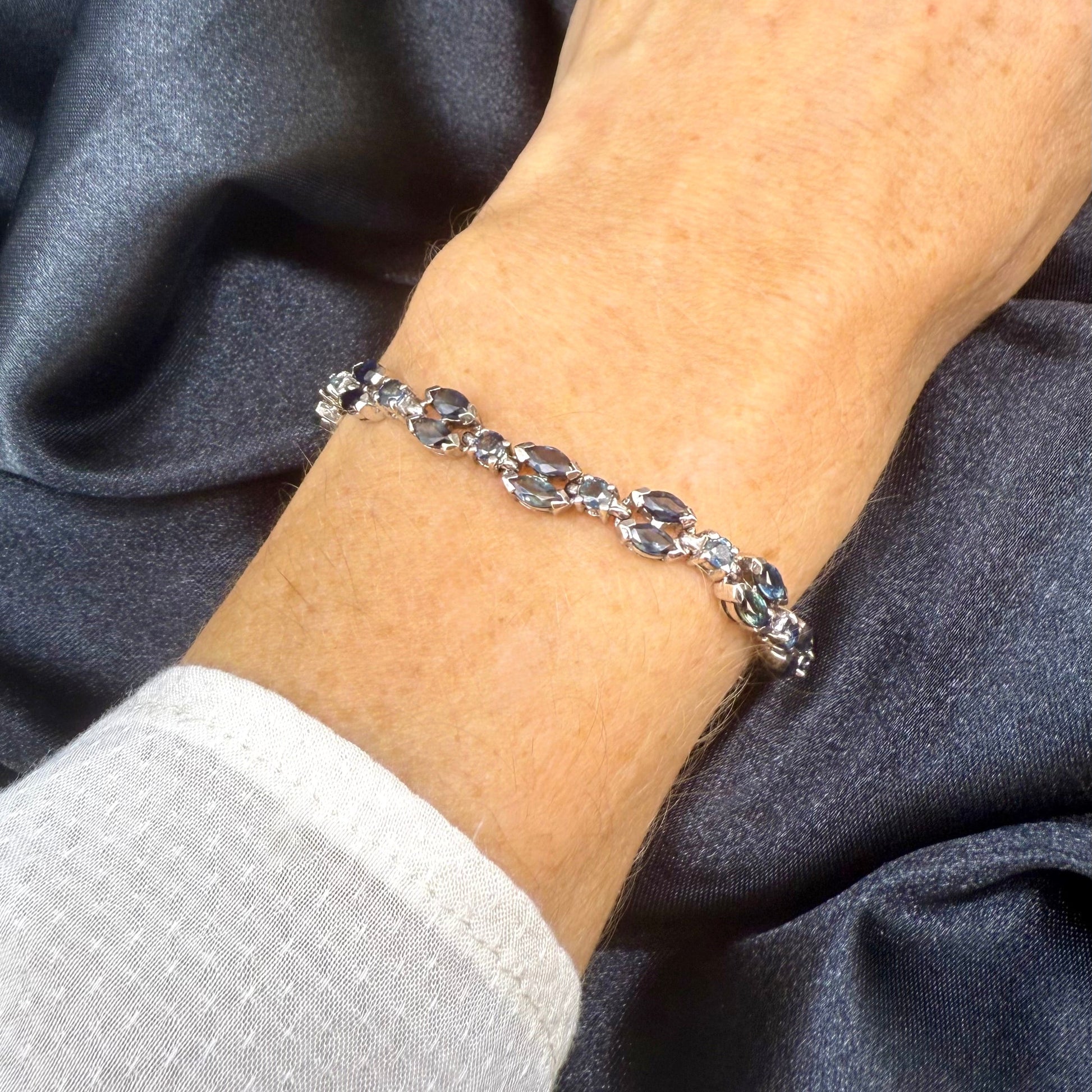 White gold plated sapphire bracelet in sterling silver on neutral background