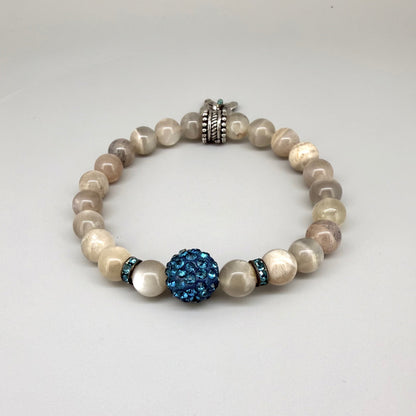 Moonstone beaded bracelet, 19cm, beige earthy gemstone beads with blue decorative bead and silver butterfly charm on elastic stretch band.