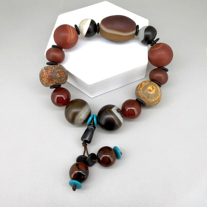 Agate and carnelian beaded bracelet, 20cm, with fiery red, brown, and colorful accent beads on elastic stretch band.