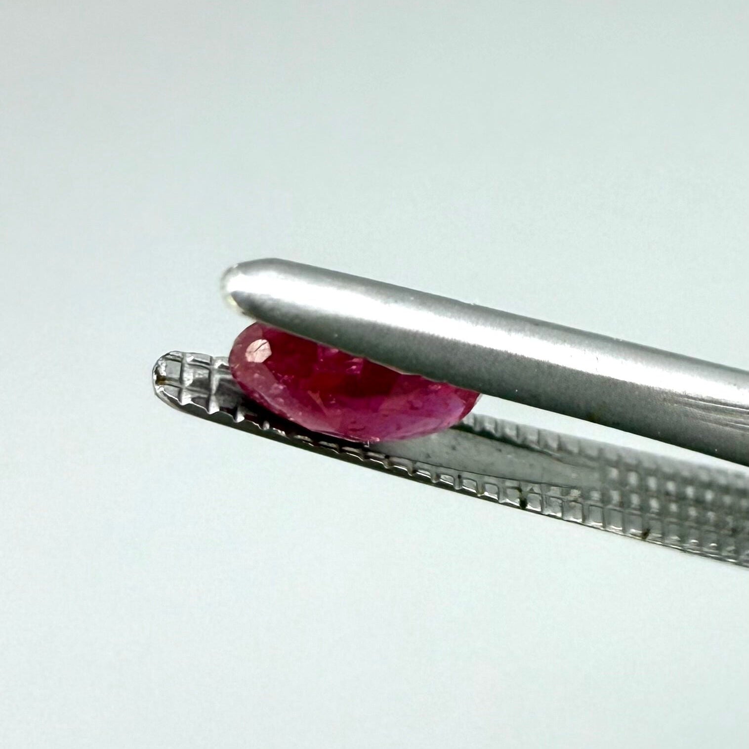 0.5 ct natural pink-red Songea ruby, oval cut.