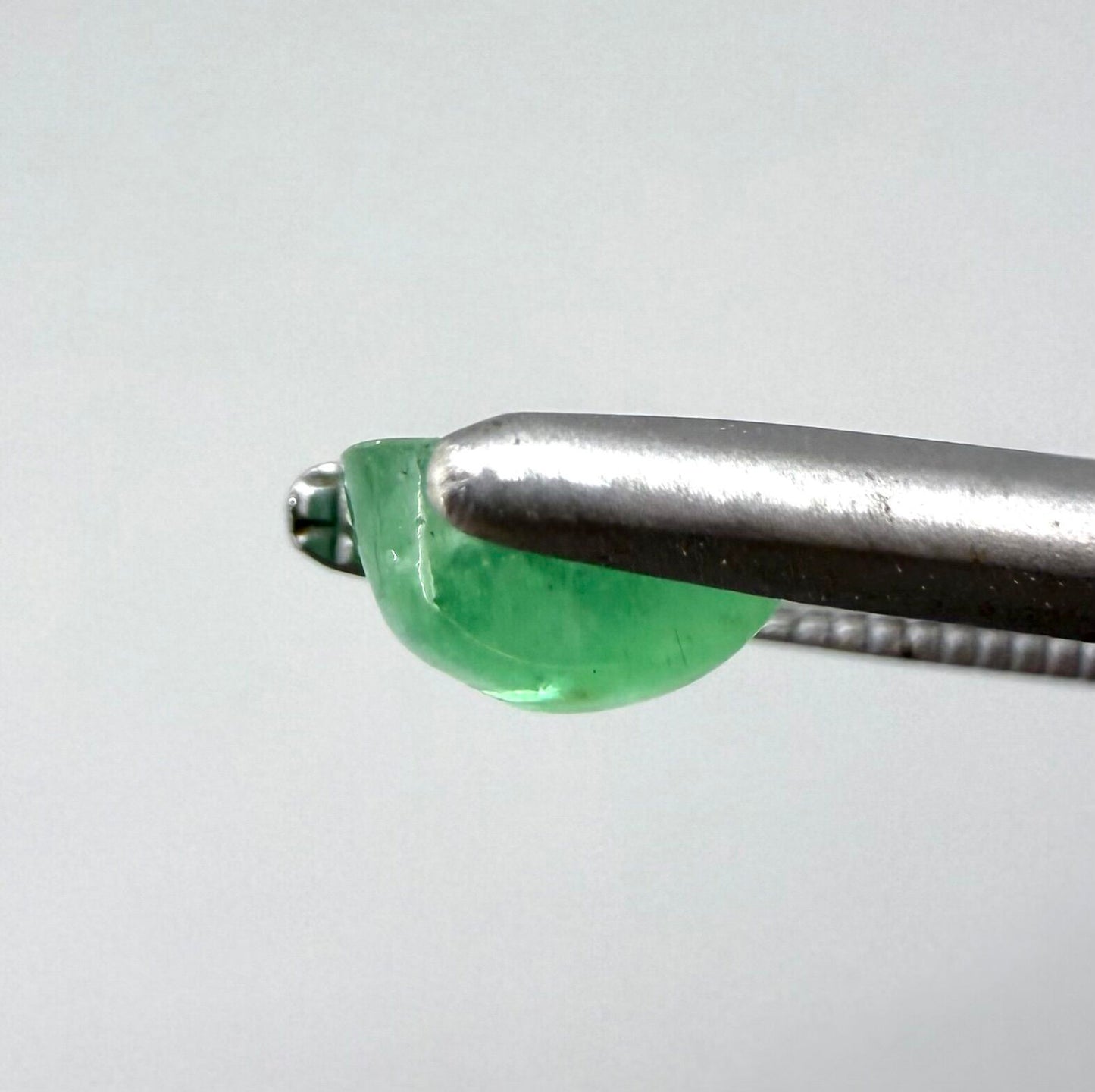 0.51 ct natural untreated emerald from Zambia, one side polished and the other cabochon-shaped.
