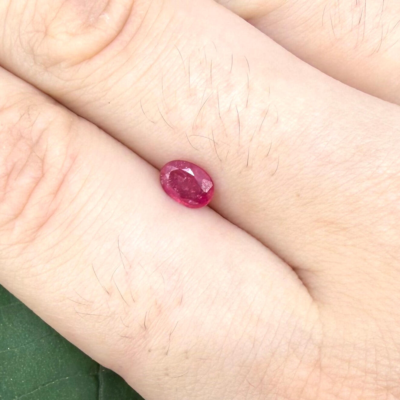 0.5 ct natural pink-red Songea ruby, oval cut.