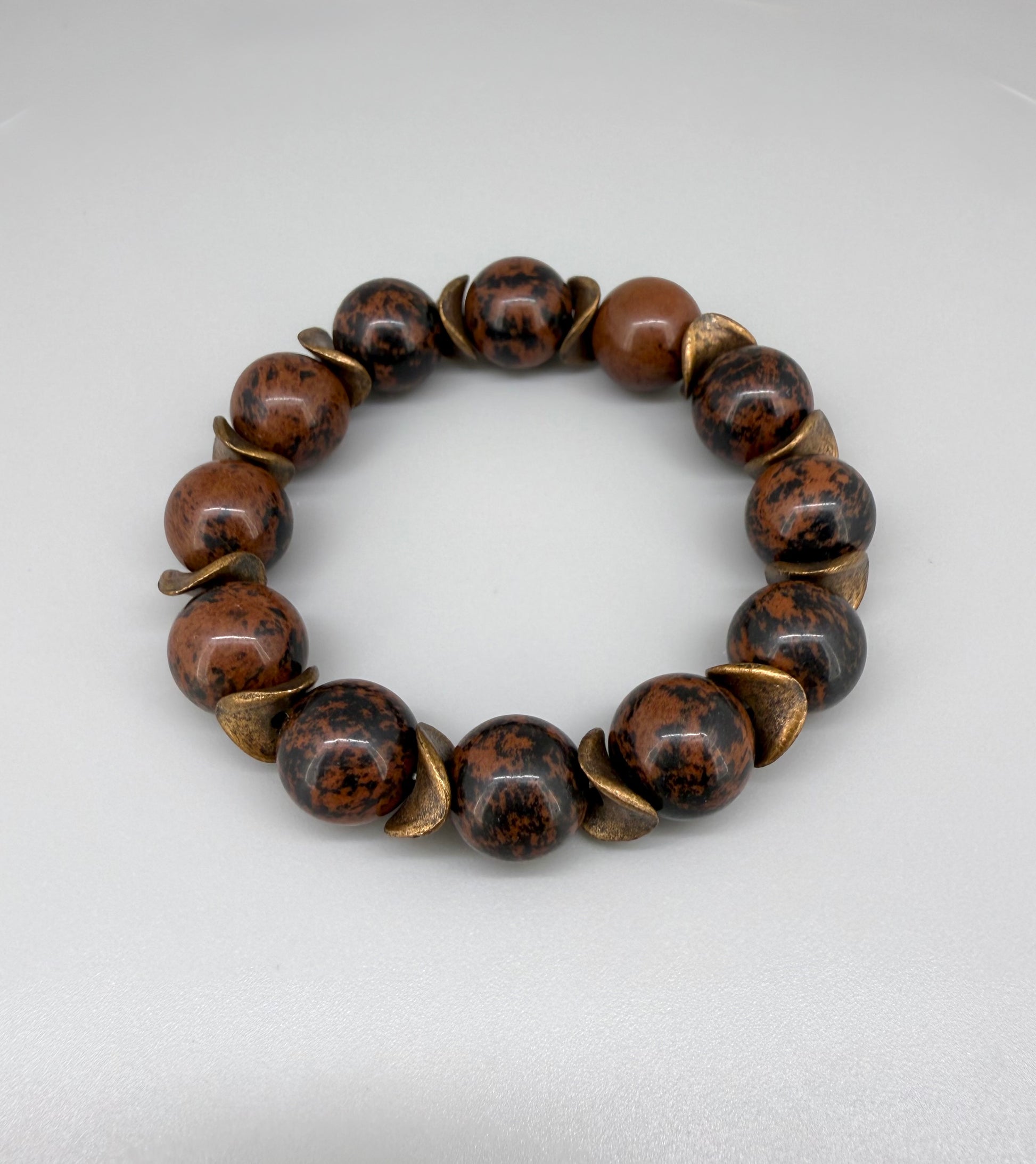 Mahogany obsidian beaded bracelet, 17cm, natural brown and black gemstone beads with copper-colored spacer accents on elastic stretch band.