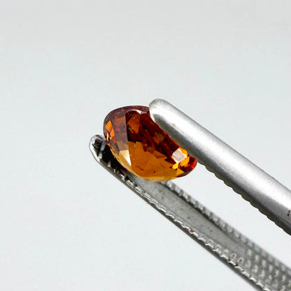 0.56 ct natural spessartine garnet from Namibia, fiery orange, faceted.
