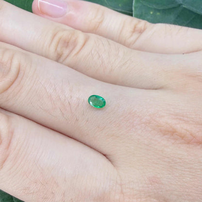 0.16 ct natural untreated Zambian emerald, oval faceted with vivid bluish-green color.