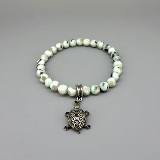 Dalmatian jasper beaded bracelet, 18cm, earthy gemstone beads with metal turtle charm on elastic stretch band.