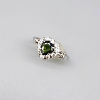 White gold plated silver solitaire ring with heart-shaped green sapphire and cubic zirconia centerpiece.