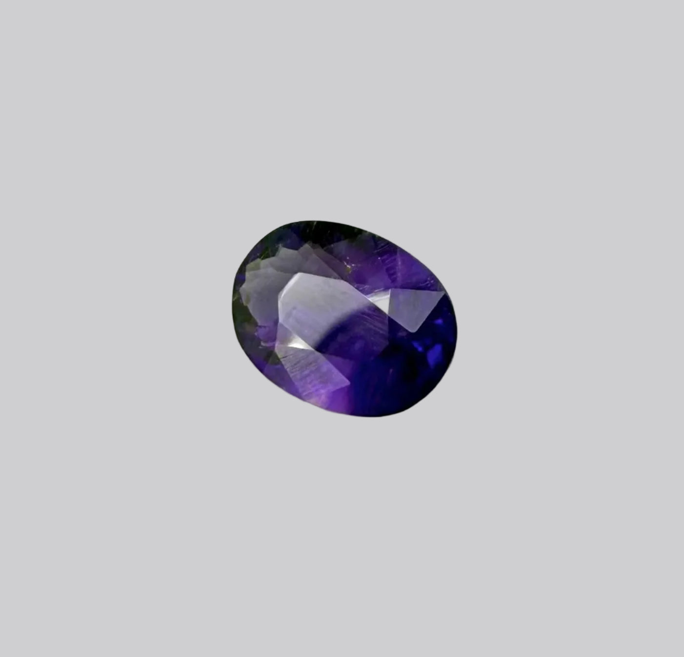 Round purple gemstone on a white background


