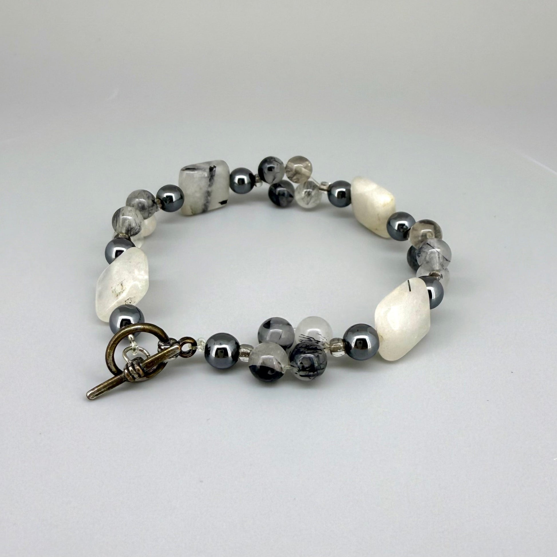 Rutilated quartz and hematite beaded bracelet, natural gemstone beads with toggle clasp.