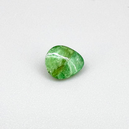 0.75 ct natural untreated emerald from Zambia, one side polished and the other cabochon-shaped.