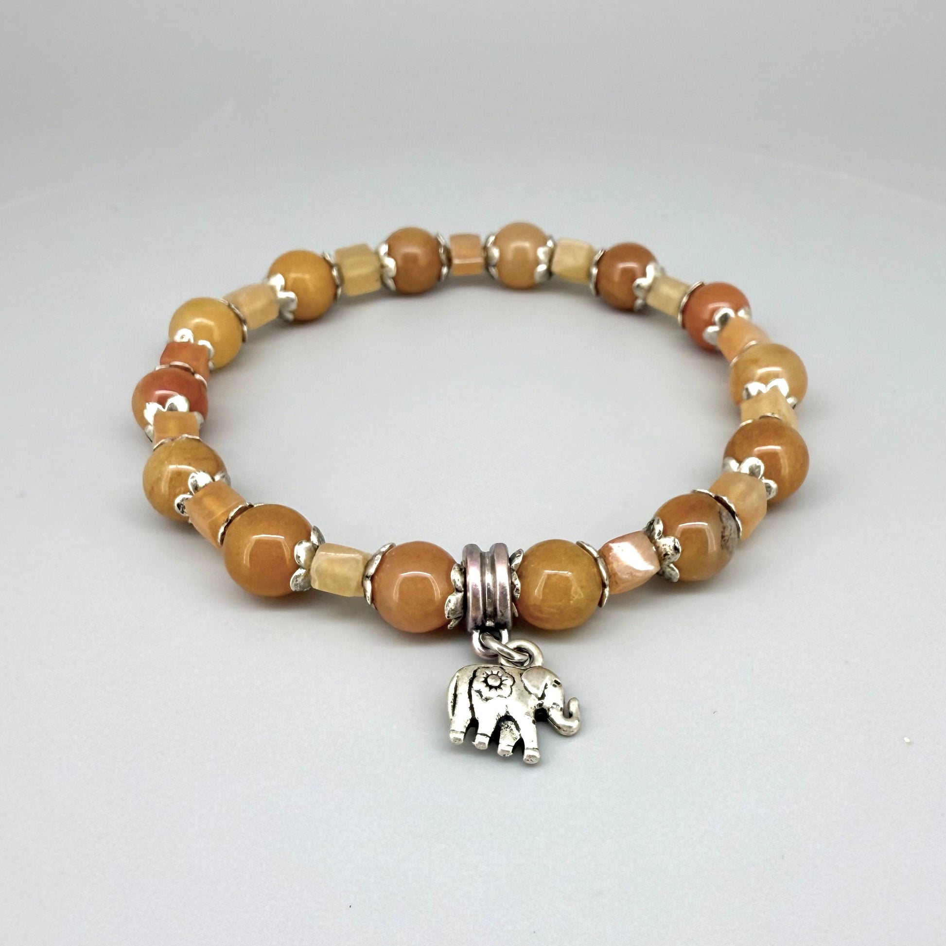 Jade and aventurine beaded bracelet, 18cm, yellow and light brown gemstone beads in round and square shapes with elephant charm on elastic stretch band.