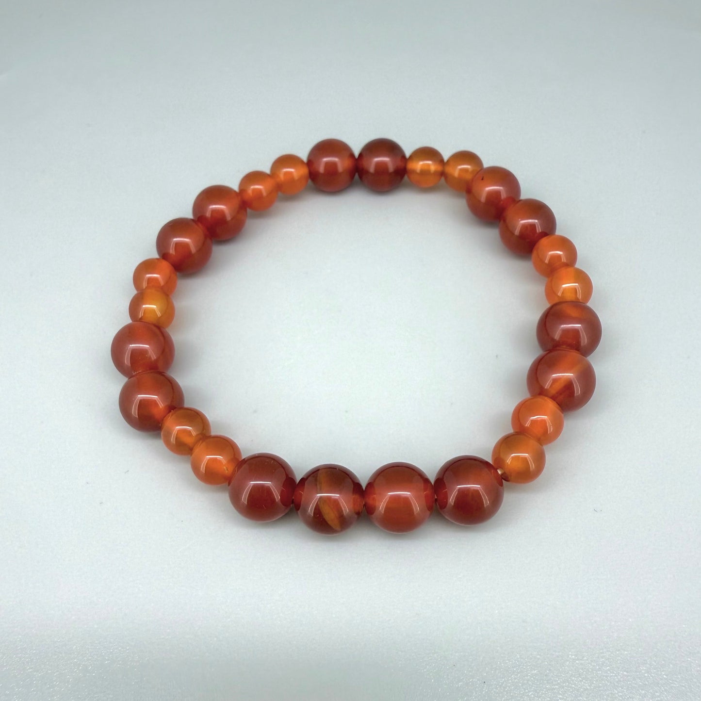 Carnelian beaded bracelet, 18cm, natural orange-red gemstone beads on elastic stretch band.