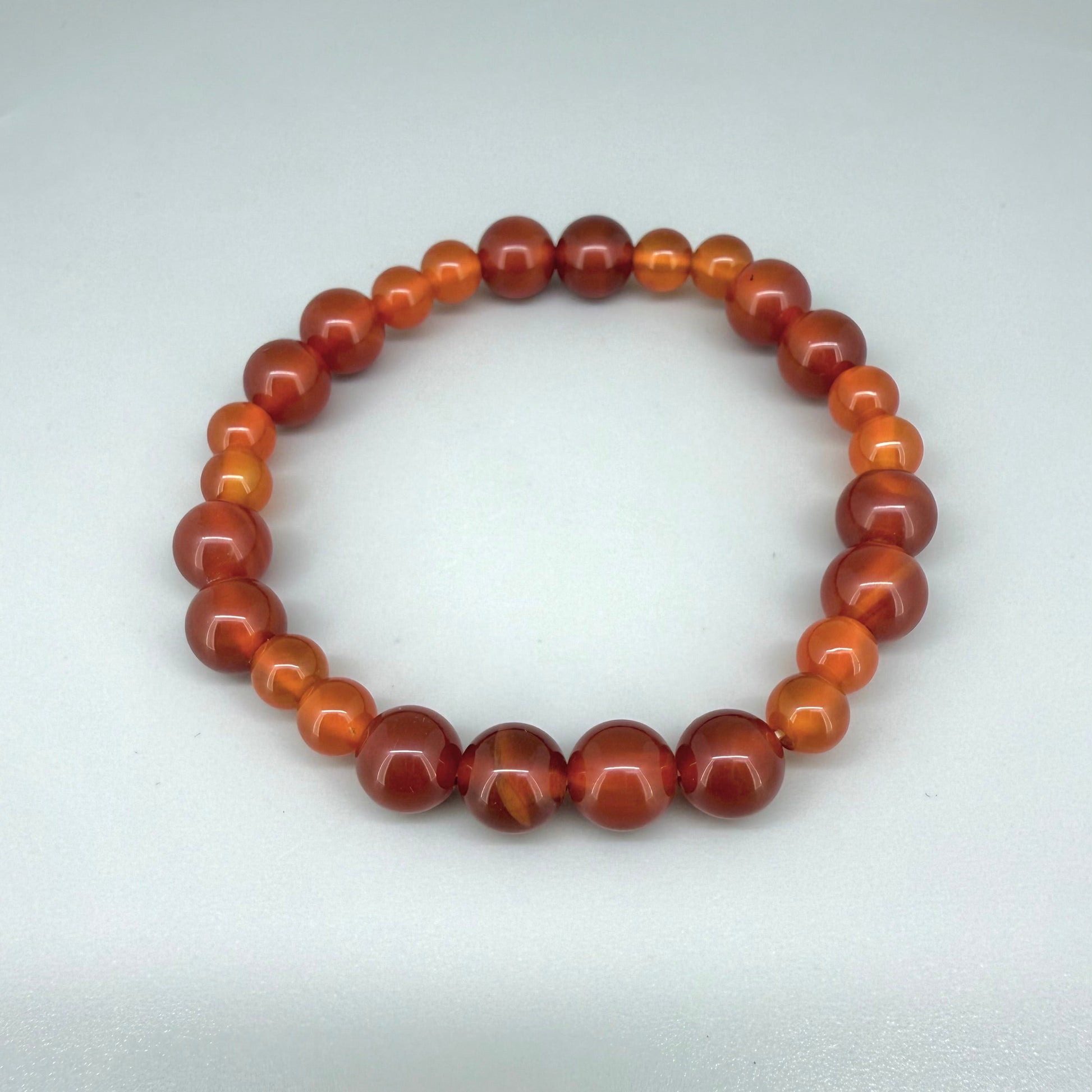 Carnelian beaded bracelet, 18cm, natural orange-red gemstone beads on elastic stretch band.
