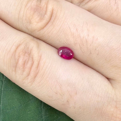 0.6 ct natural Songea ruby, oval cut in a pink-red tone.
