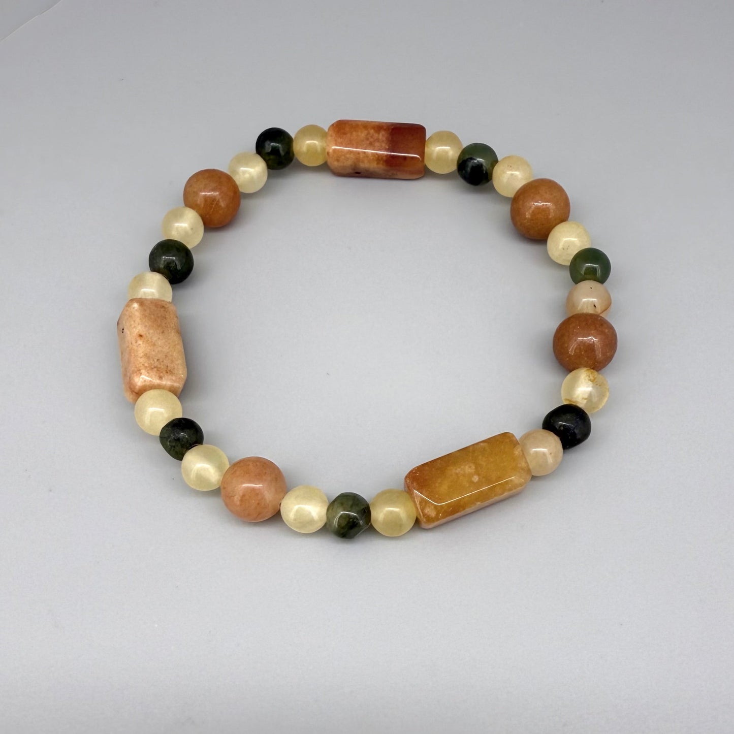 Jade beaded bracelet, 19cm, orange square stones with round beads in orange, green, and beige tones on elastic stretch band.