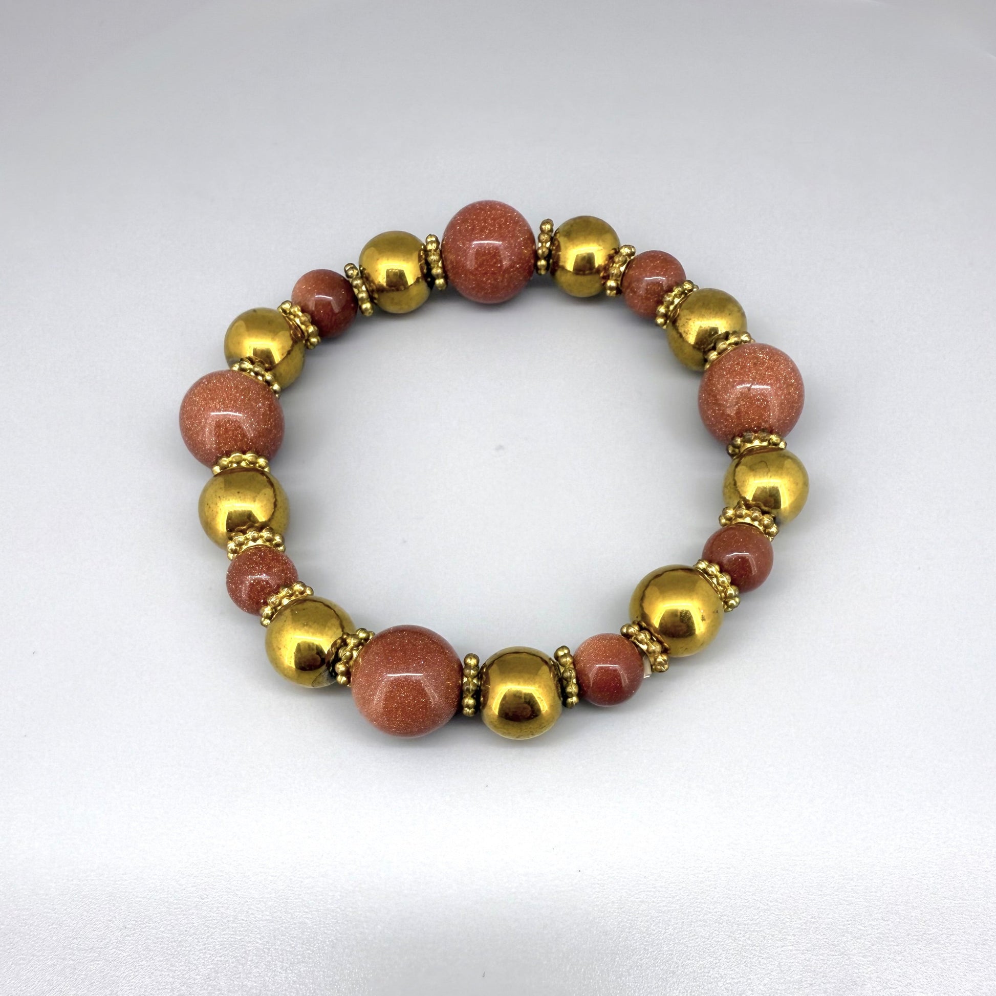 Hematite and goldstone beaded bracelet, 18cm, metallic gold and shimmering golden-copper beads on elastic stretch band.