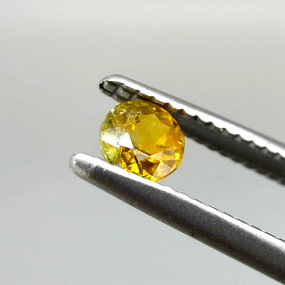 0.2 ct natural orange sapphire from Bangkaja, round cut.