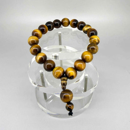 Tiger’s Eye mala bracelet with golden-brown chatoyant gemstone beads worn on wrist.