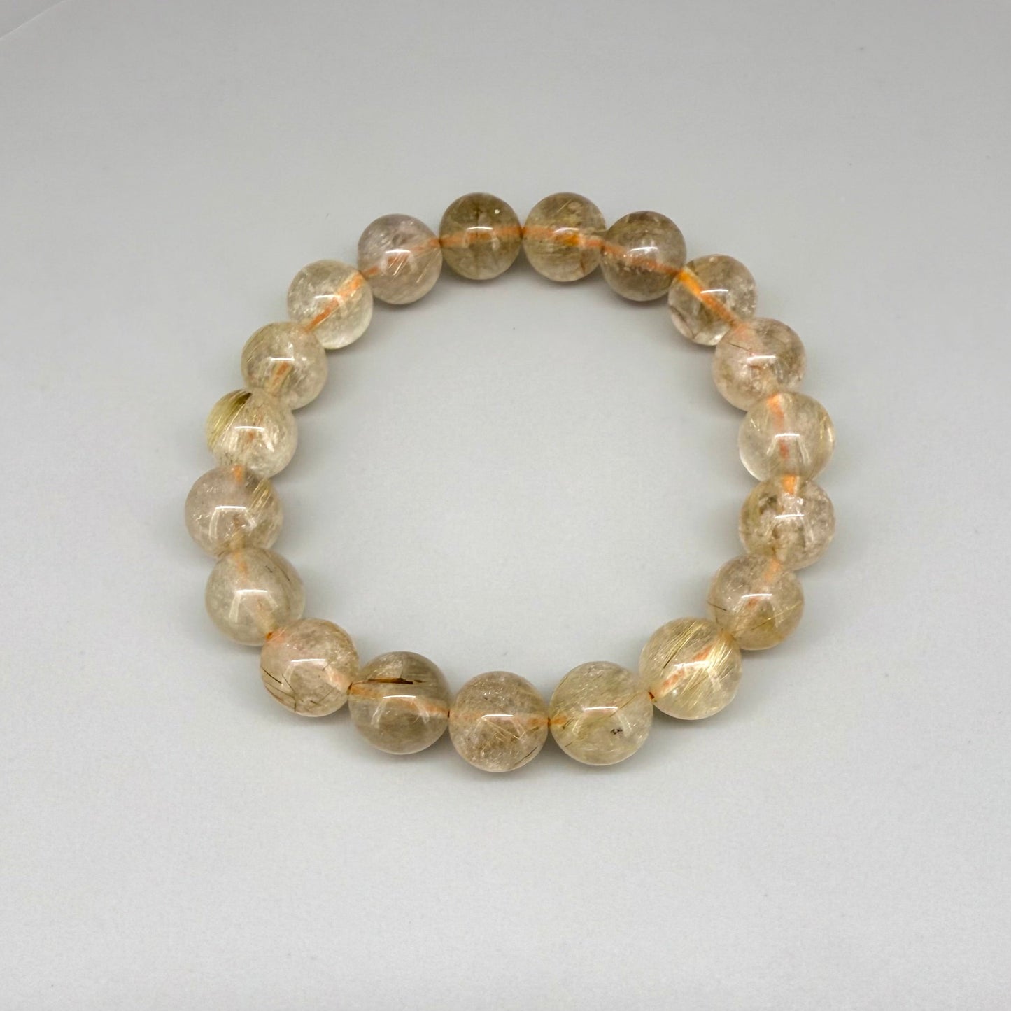 Bronze rutilated quartz beaded bracelet, 18cm, natural gemstone beads with bronze rutile threads on elastic stretch band.